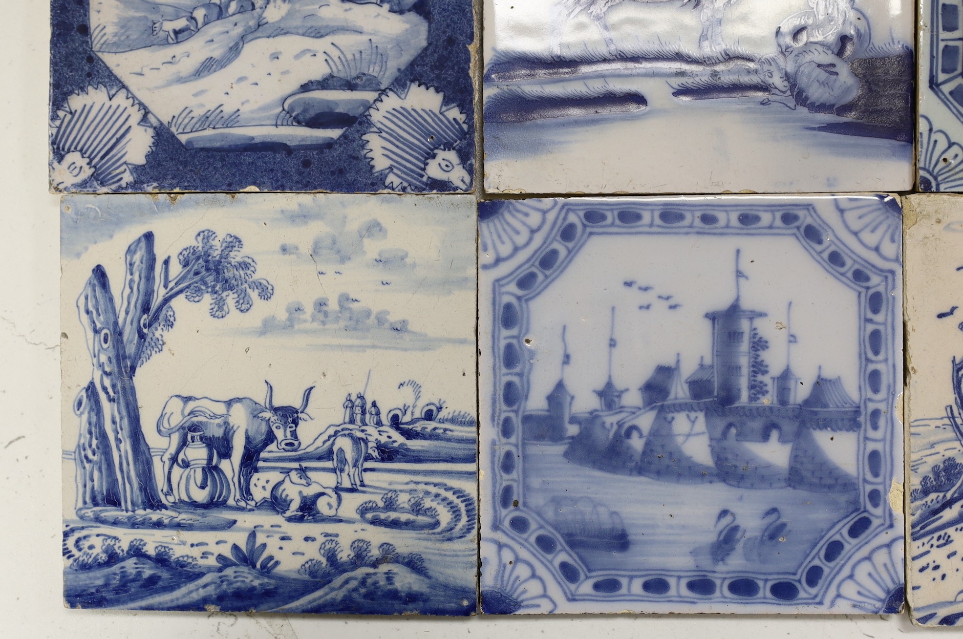 Nine various Delft blue and white landscape or animal tiles, 18th/19th century